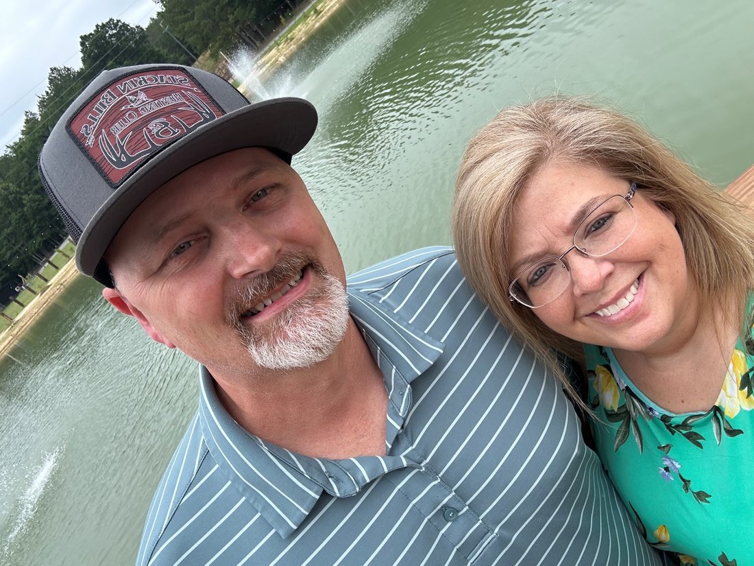 Brannon and his wife by a fountain
